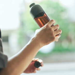 WATER BOTTLE (black × amber) in hand